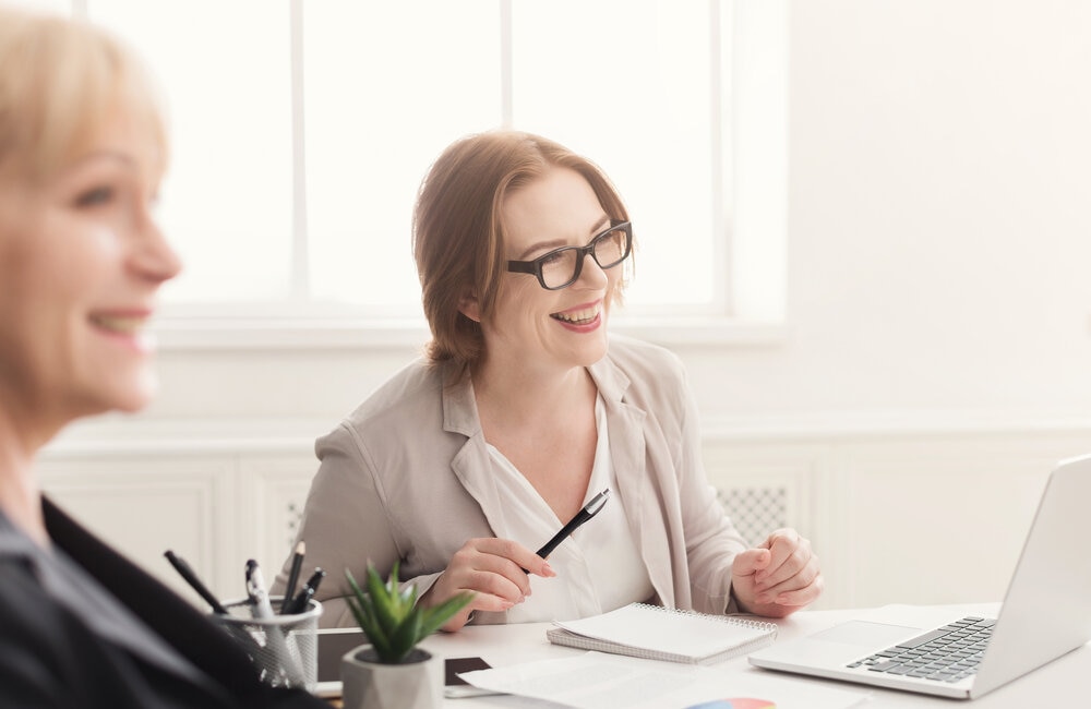 two woman in the office working in IT sector