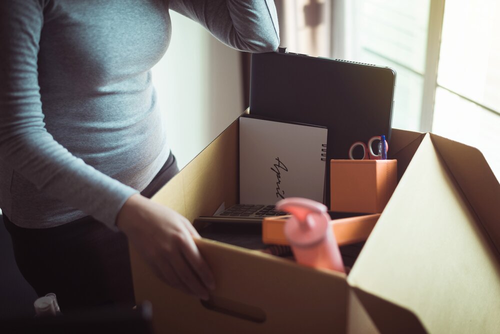 shecession concept, woman holding box and equipment from work,Unemployment job concept