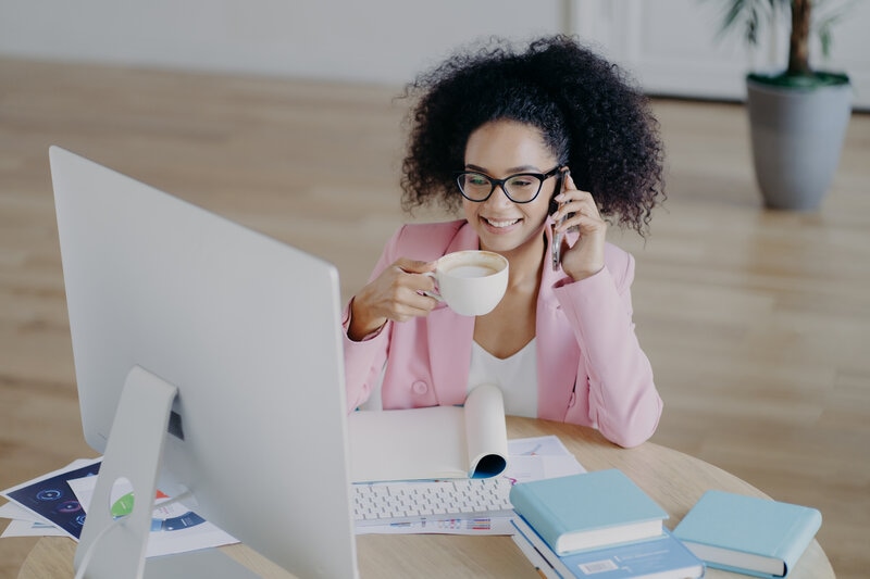 Happy african american businesswoman talking to client on the phone