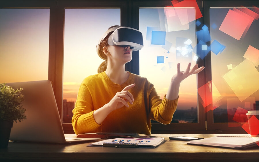 woman wearing VR goggles working in the metaverse