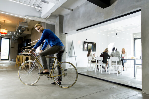 man commutes by bicycle to his eco friendly workplace