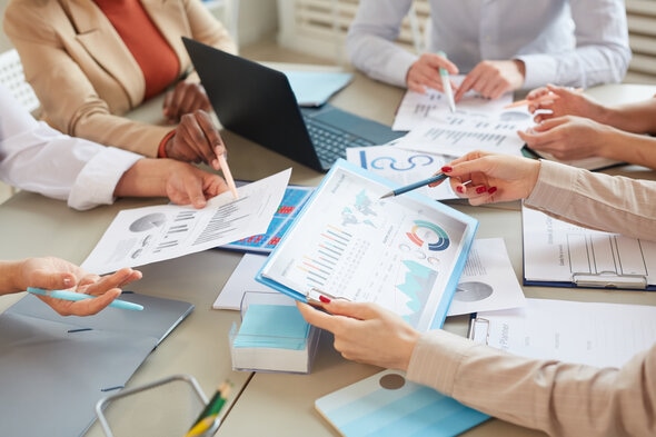 Business team looking at paper data charts