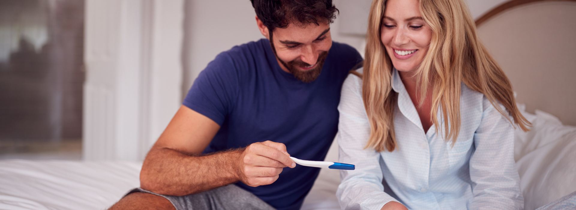 Excited couple looking at pregnancy test